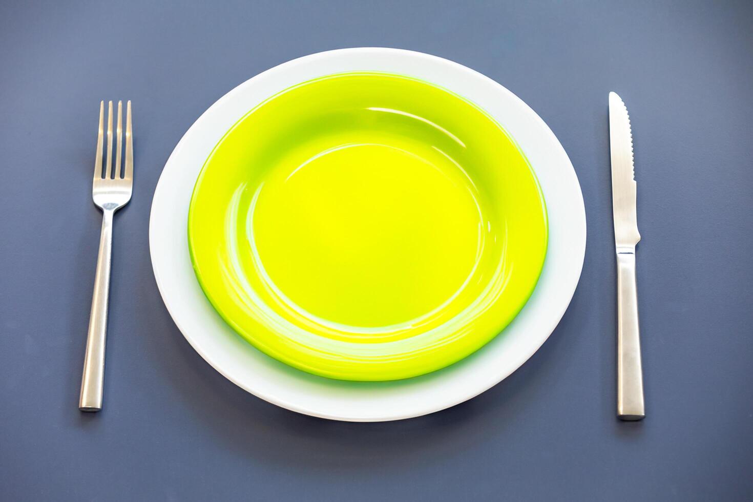 Empty plate top view with metal cutlery next to it photo