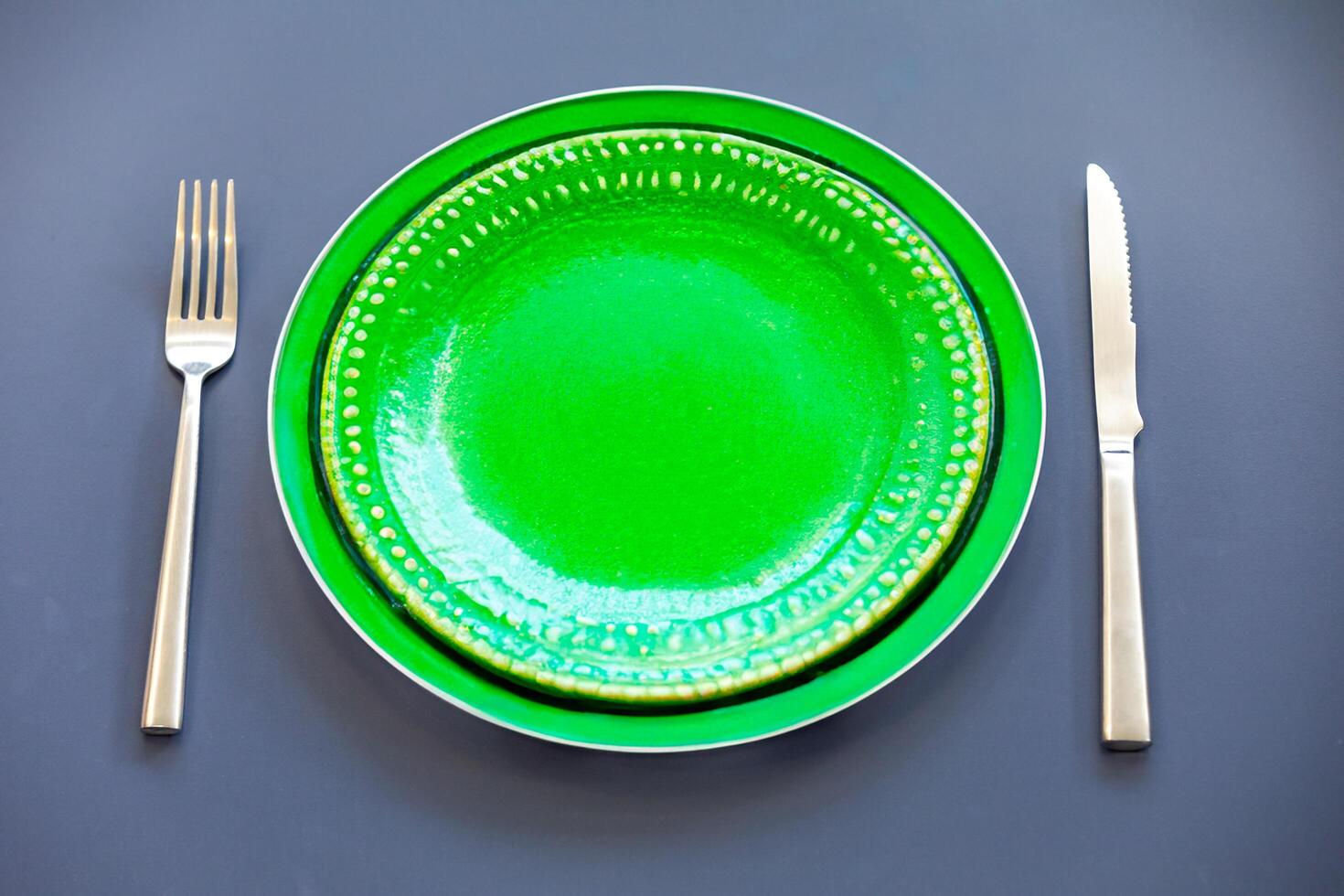 Empty plate top view with metal cutlery next to it photo