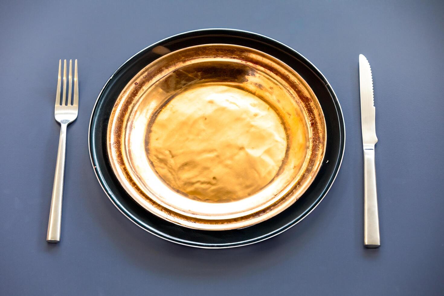 Empty plate top view with metal cutlery next to it photo