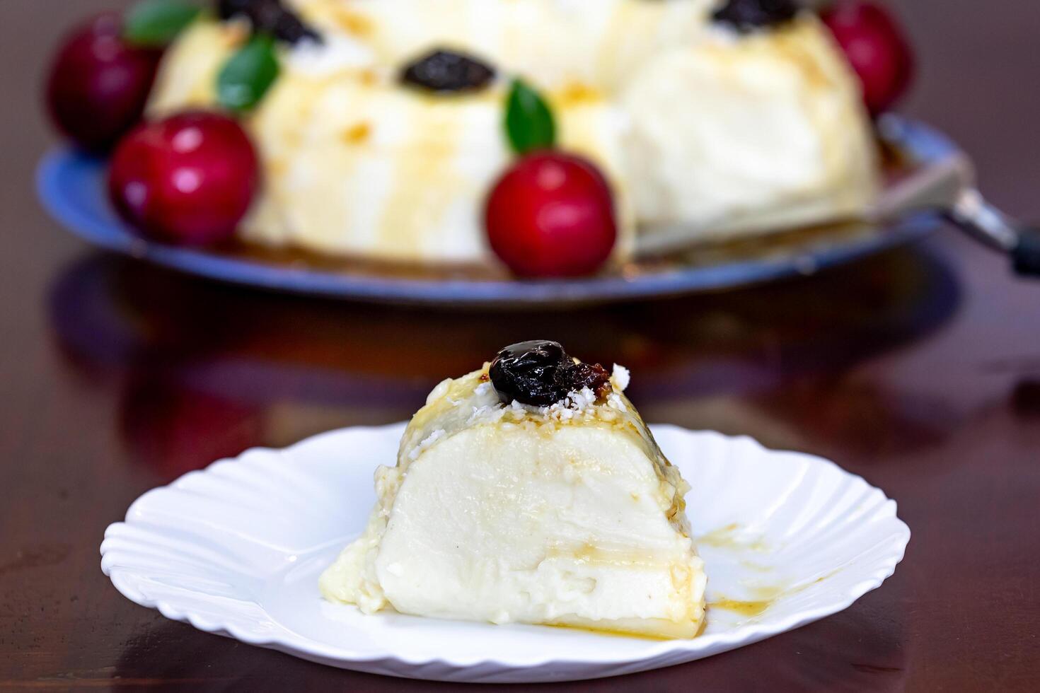 Traditional Brazilian coconut flan dessert known as manjar branco, manjar de coco and manjar dos deuses. Served with plum syrup. photo