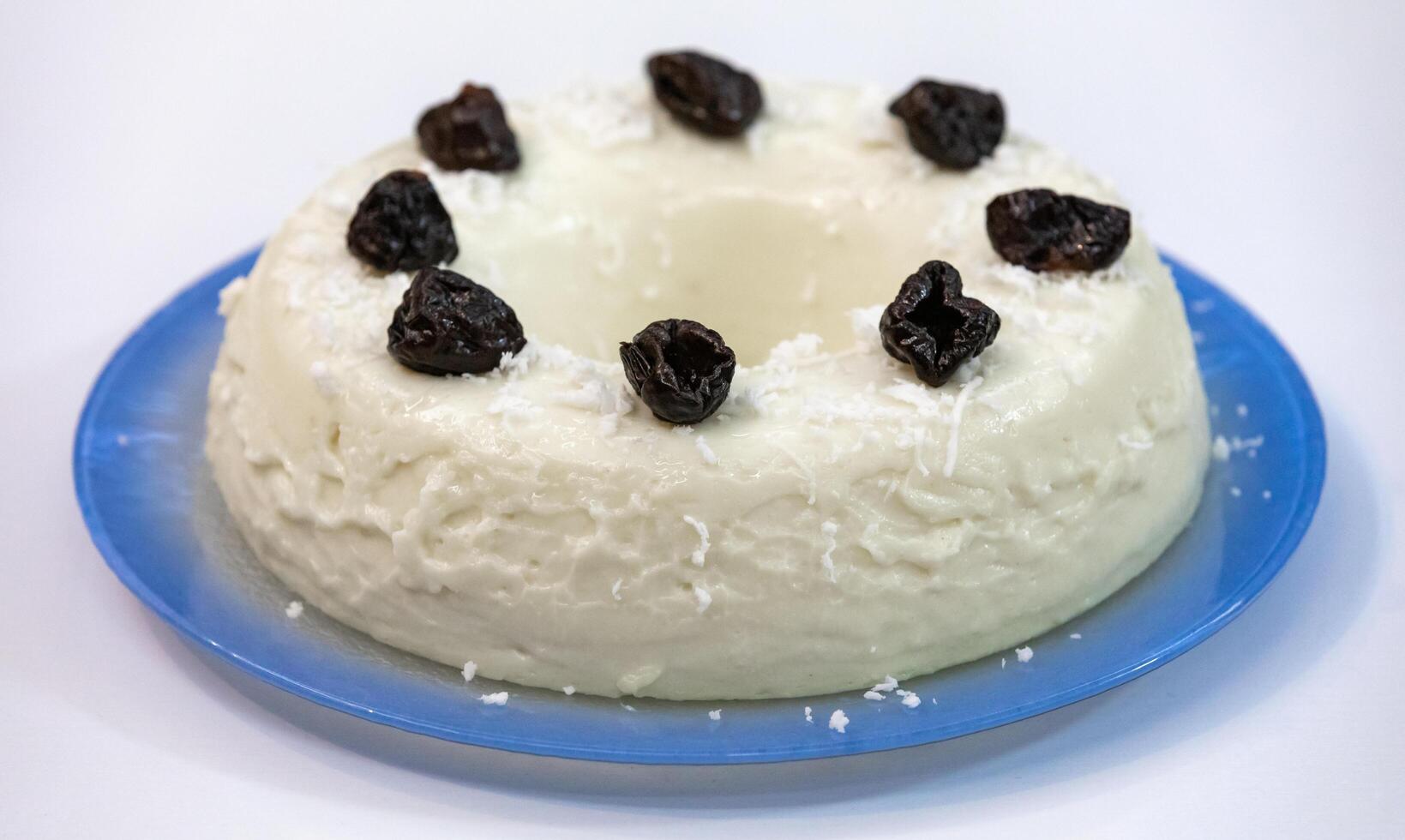 Traditional Brazilian coconut flan dessert known as manjar branco, manjar de coco and manjar dos deuses. Served with plum syrup. photo
