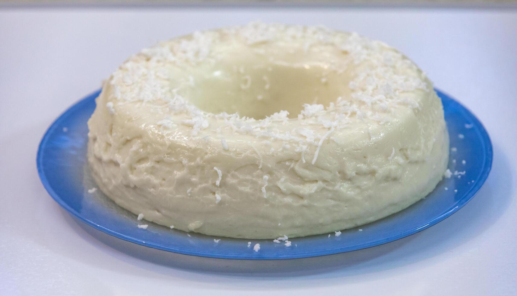 Traditional Brazilian coconut flan dessert known as manjar branco, manjar de coco and manjar dos deuses. Served with plum syrup. photo