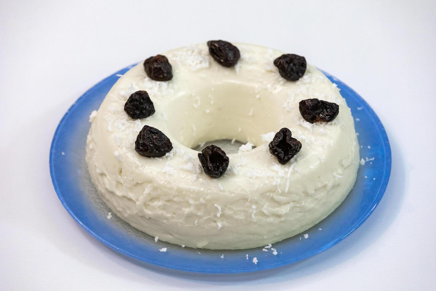 Traditional Brazilian coconut flan dessert known as manjar branco, manjar de coco and manjar dos deuses. Served with plum syrup. photo