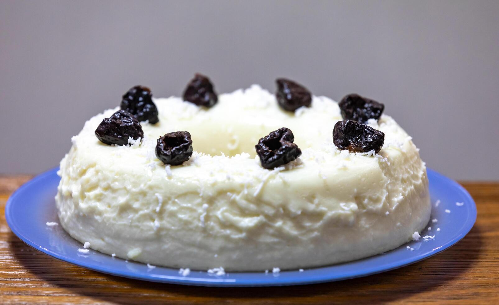Traditional Brazilian coconut flan dessert known as manjar branco, manjar de coco and manjar dos deuses. Served with plum syrup. photo