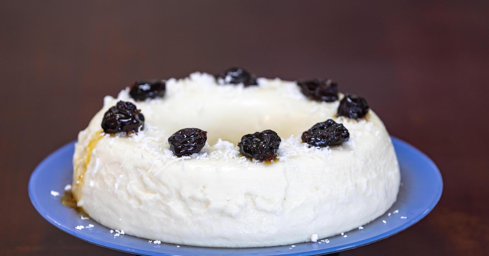 Traditional Brazilian coconut flan dessert known as manjar branco, manjar de coco and manjar dos deuses. Served with plum syrup. photo