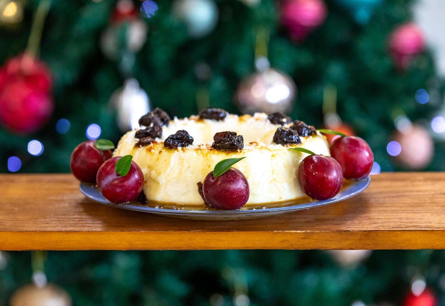 Traditional Brazilian coconut flan dessert known as manjar branco, manjar de coco and manjar dos deuses. Served with plum syrup. photo