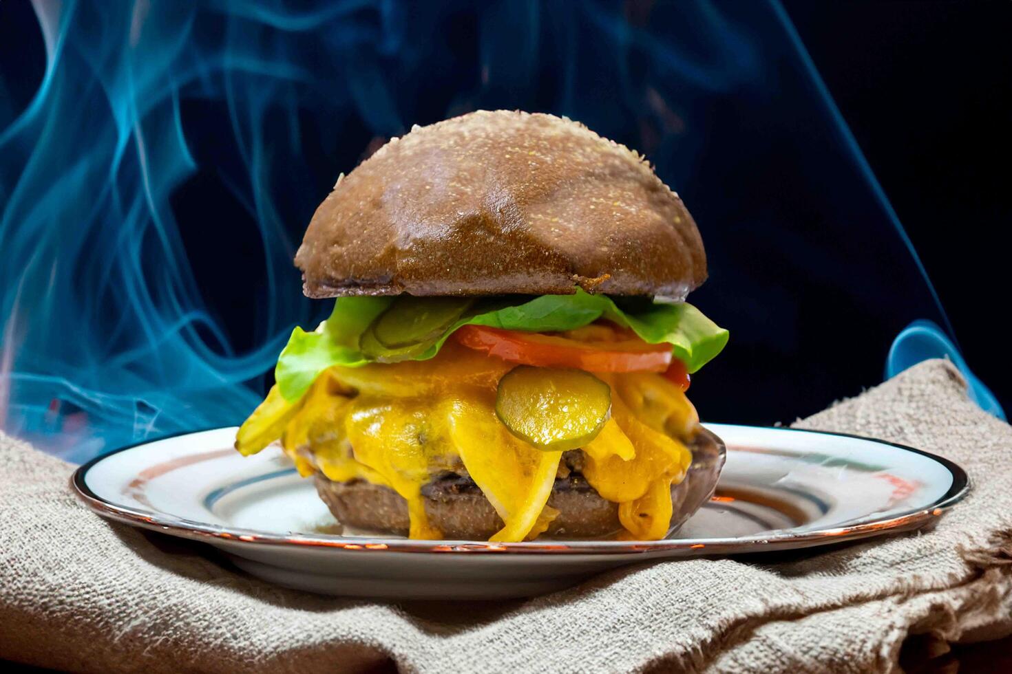 Traditional rustic burger sandwich with cheddar cheese, vegetables and Australian bread in creative photography and cozy village setting photo