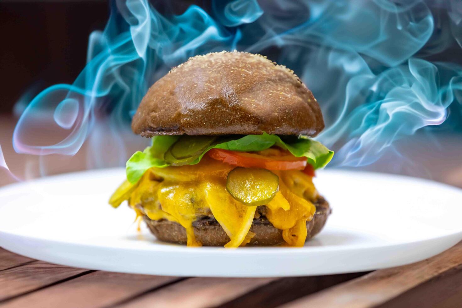 Traditional rustic burger sandwich with cheddar cheese, vegetables and Australian bread in creative photography and cozy village setting photo