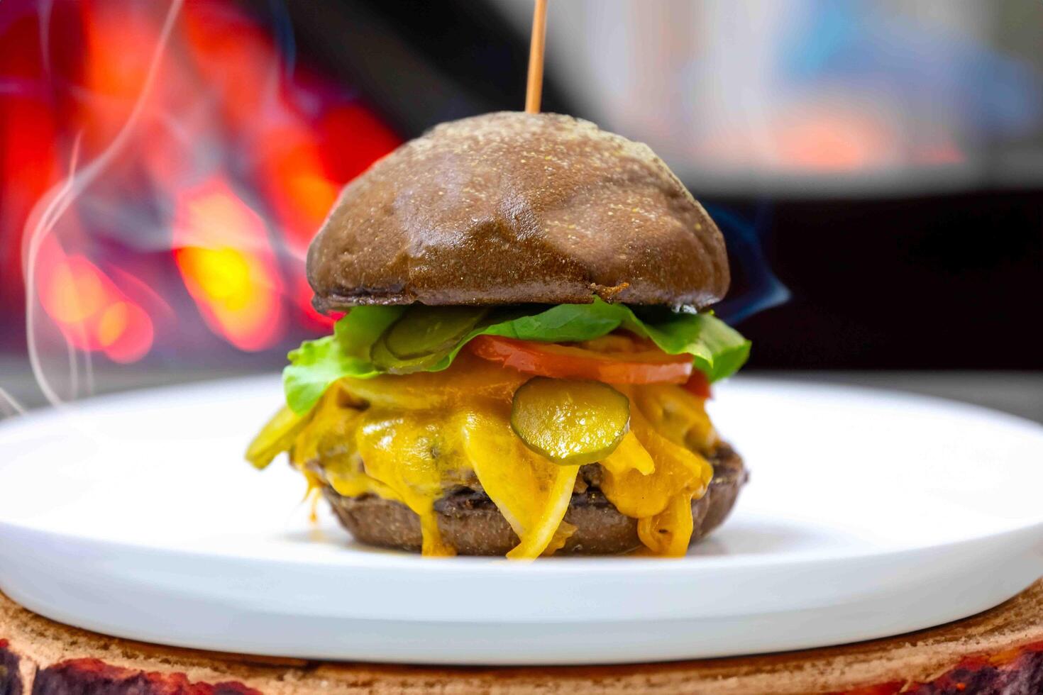 Traditional rustic burger sandwich with cheddar cheese, vegetables and Australian bread in creative photography and cozy village setting photo