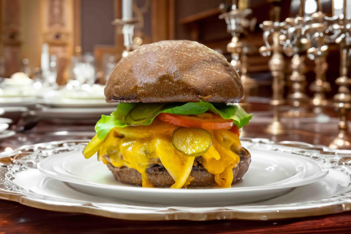 Traditional rustic burger sandwich with cheddar cheese, vegetables and Australian bread in creative photography and cozy village setting photo