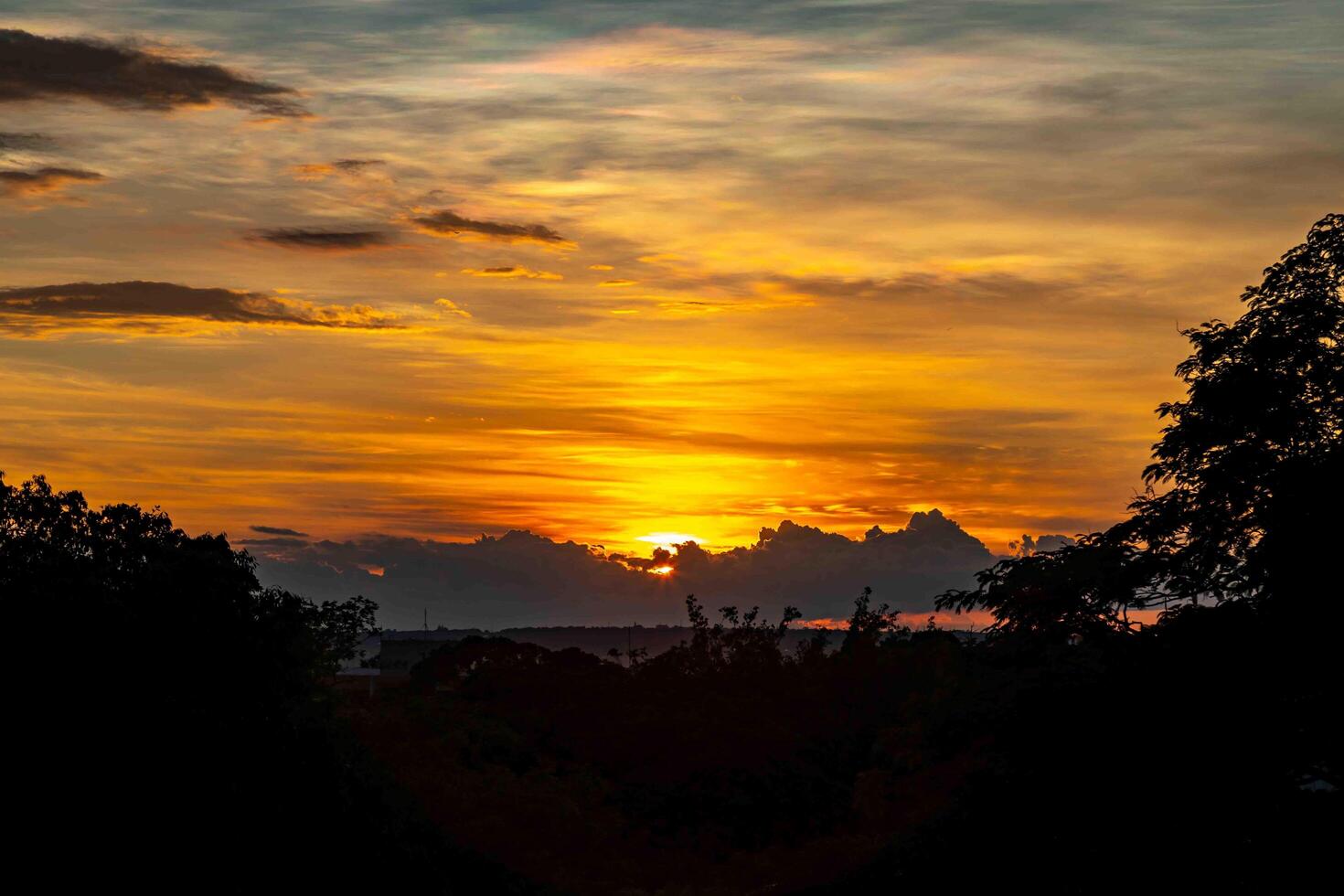 Sunrise with intense natural orange lights and idyllic dramatic scenery photo