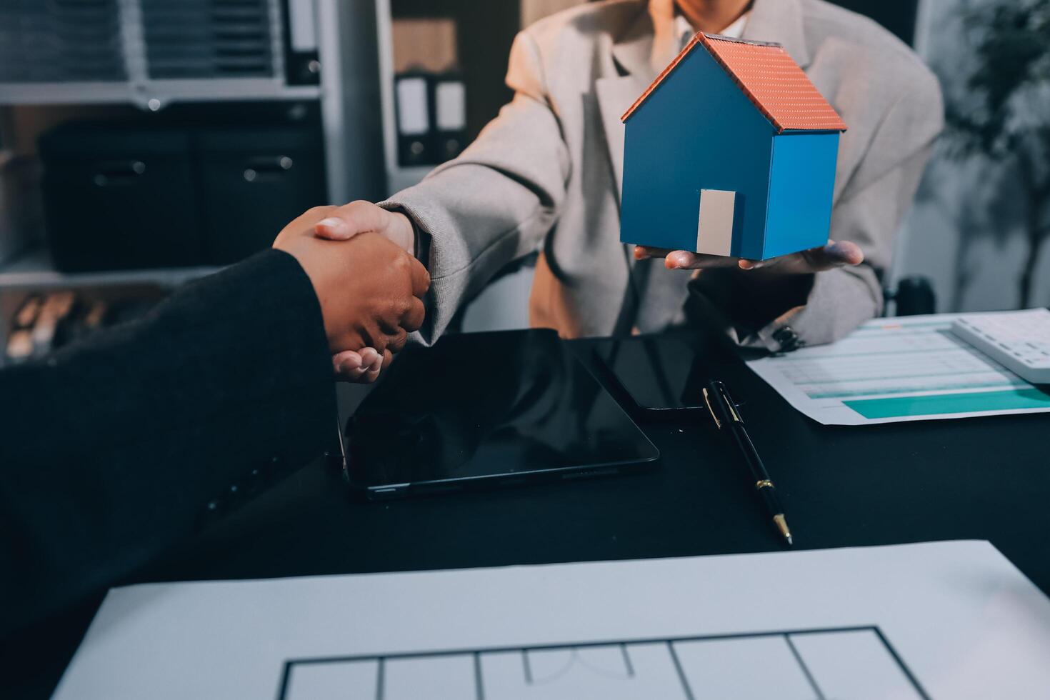 Close up Business people or Real Estate agent explain signing agreement for sale house to client. Property, Insurance, Broker concept. photo