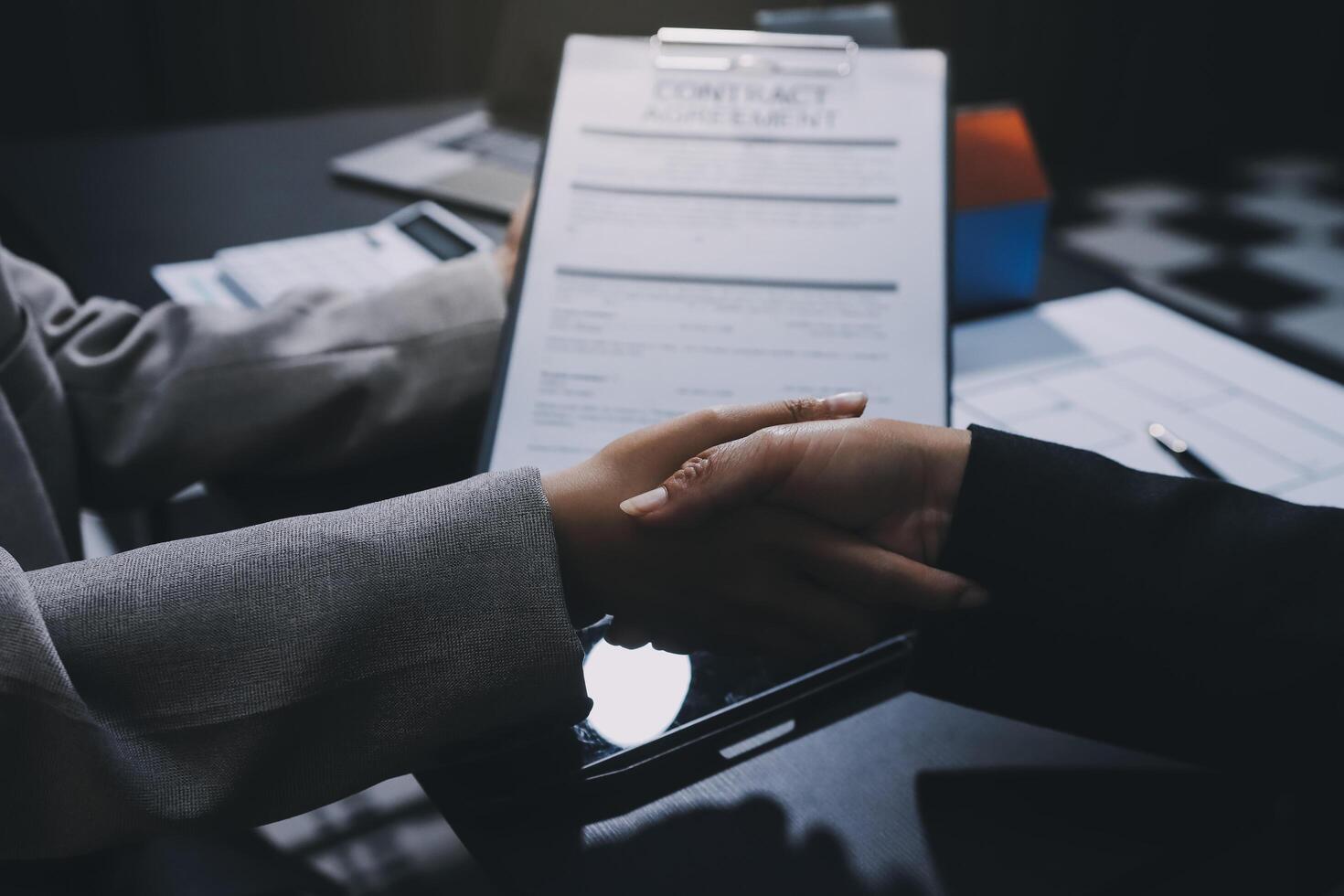 Close up Business people or Real Estate agent explain signing agreement for sale house to client. Property, Insurance, Broker concept. photo