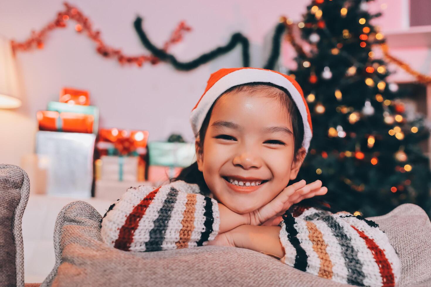 christmas, x-mas, winter, happiness concept - dreaming girl in santa helper hat photo