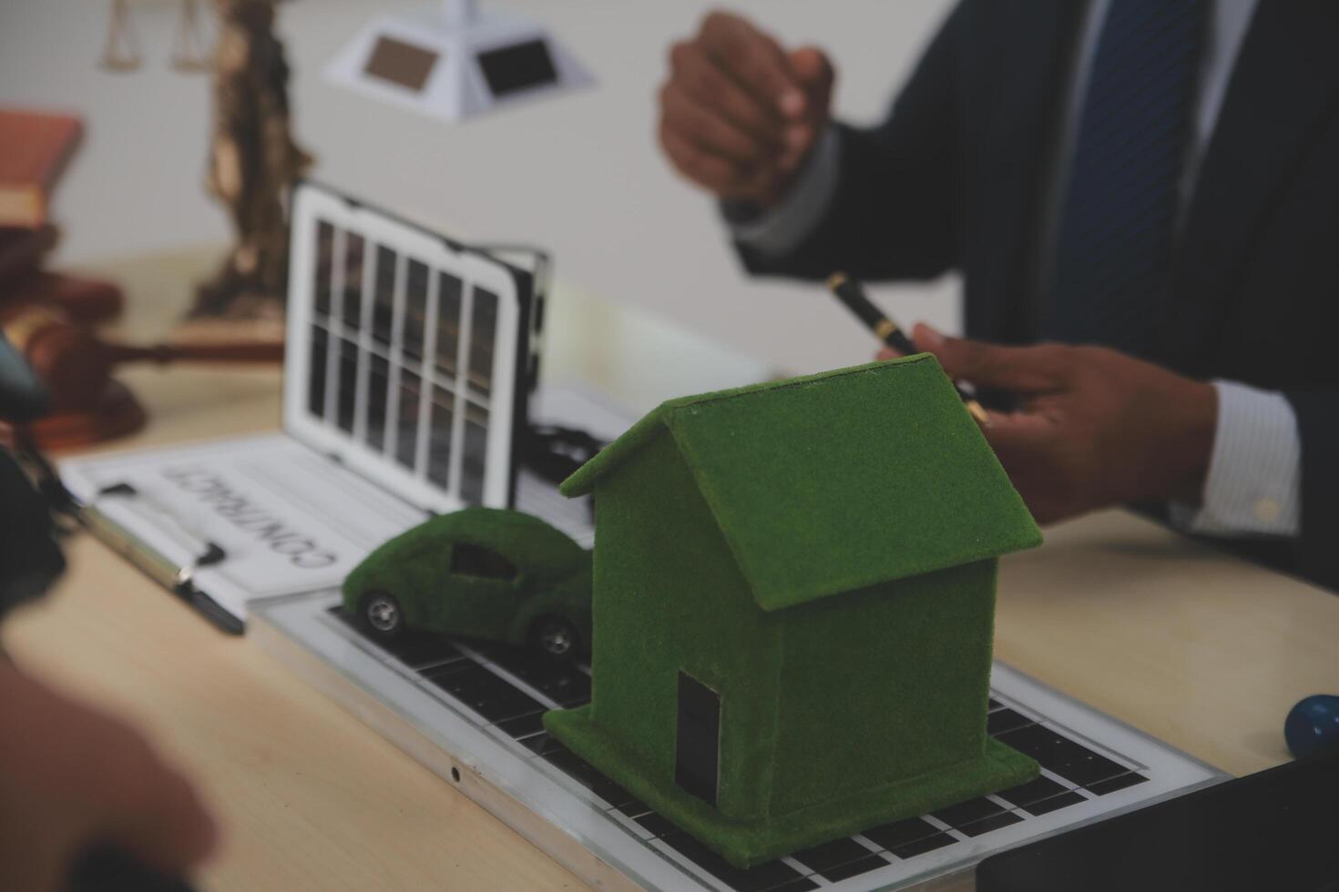 Auctioneer knocks down property sale by sample house and lawyer's gavel, judge mediates in property dispute in court car judge's gavel on wooden background Buying and selling real estate, housing photo