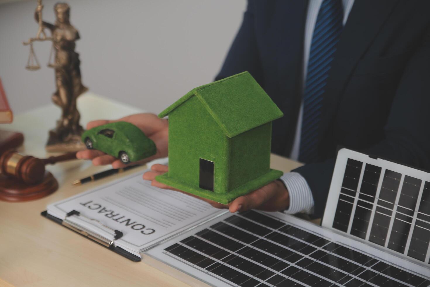 Auctioneer knocks down property sale by sample house and lawyer's gavel, judge mediates in property dispute in court car judge's gavel on wooden background Buying and selling real estate, housing photo