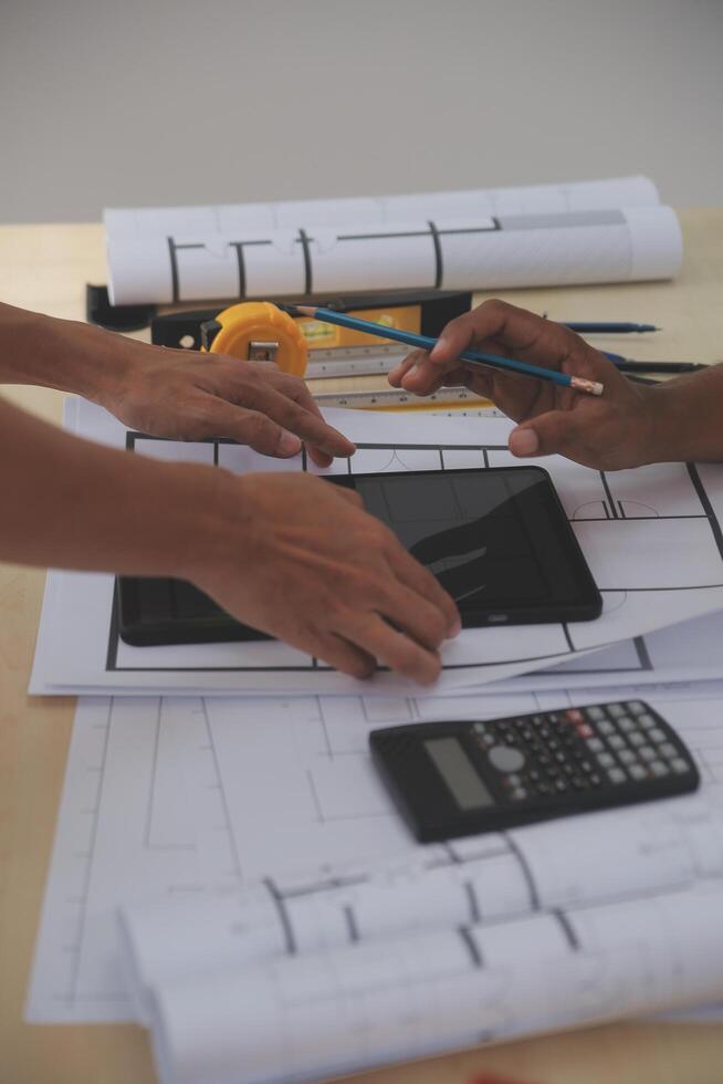 Image of engineer meeting for architectural project. working with partner and engineering tools on workplace vintage tone. photo