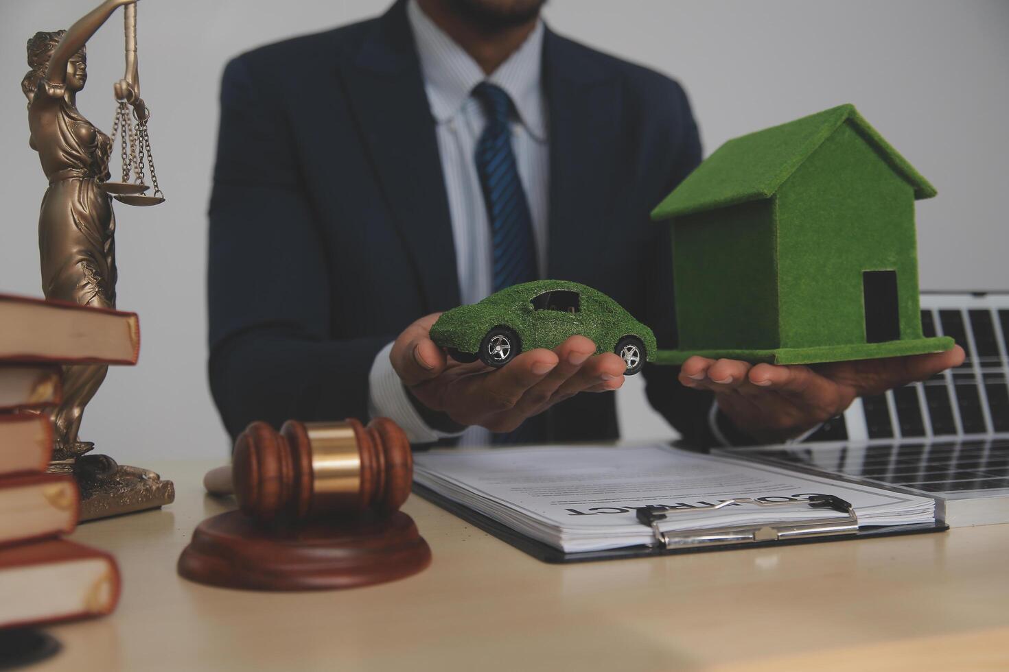 Auctioneer knocks down property sale by sample house and lawyer's gavel, judge mediates in property dispute in court car judge's gavel on wooden background Buying and selling real estate, housing photo