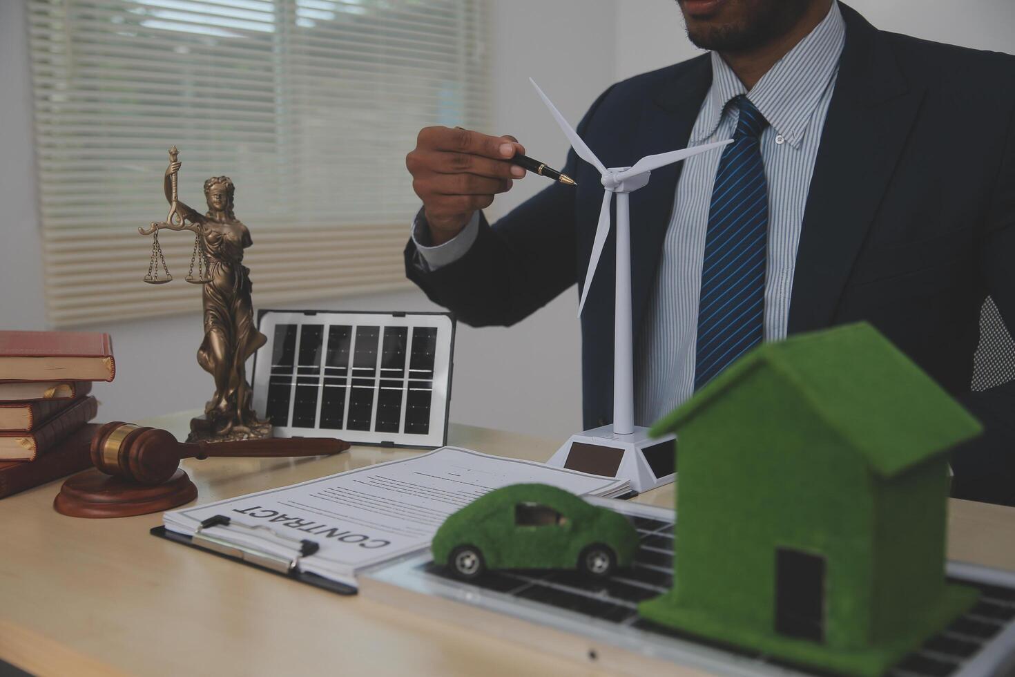 Auctioneer knocks down property sale by sample house and lawyer's gavel, judge mediates in property dispute in court car judge's gavel on wooden background Buying and selling real estate, housing photo