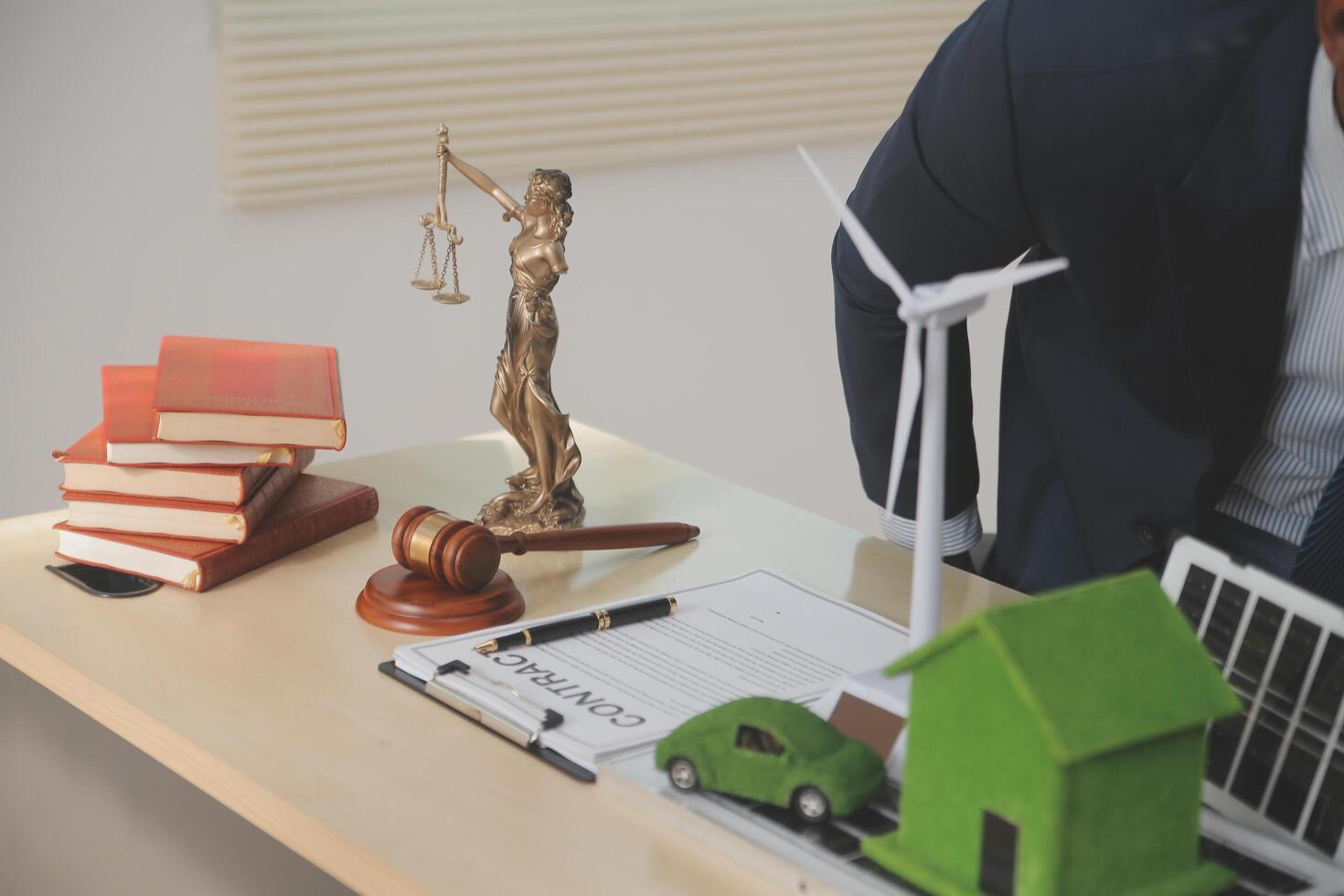 Auctioneer knocks down property sale by sample house and lawyer's gavel, judge mediates in property dispute in court car judge's gavel on wooden background Buying and selling real estate, housing photo