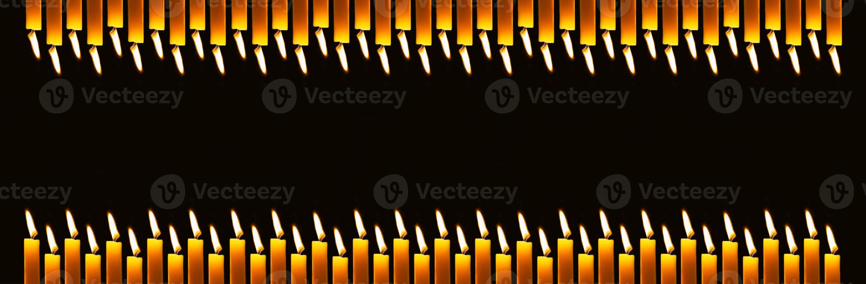 Wax candles burning in darkness. Long banner with copy space photo