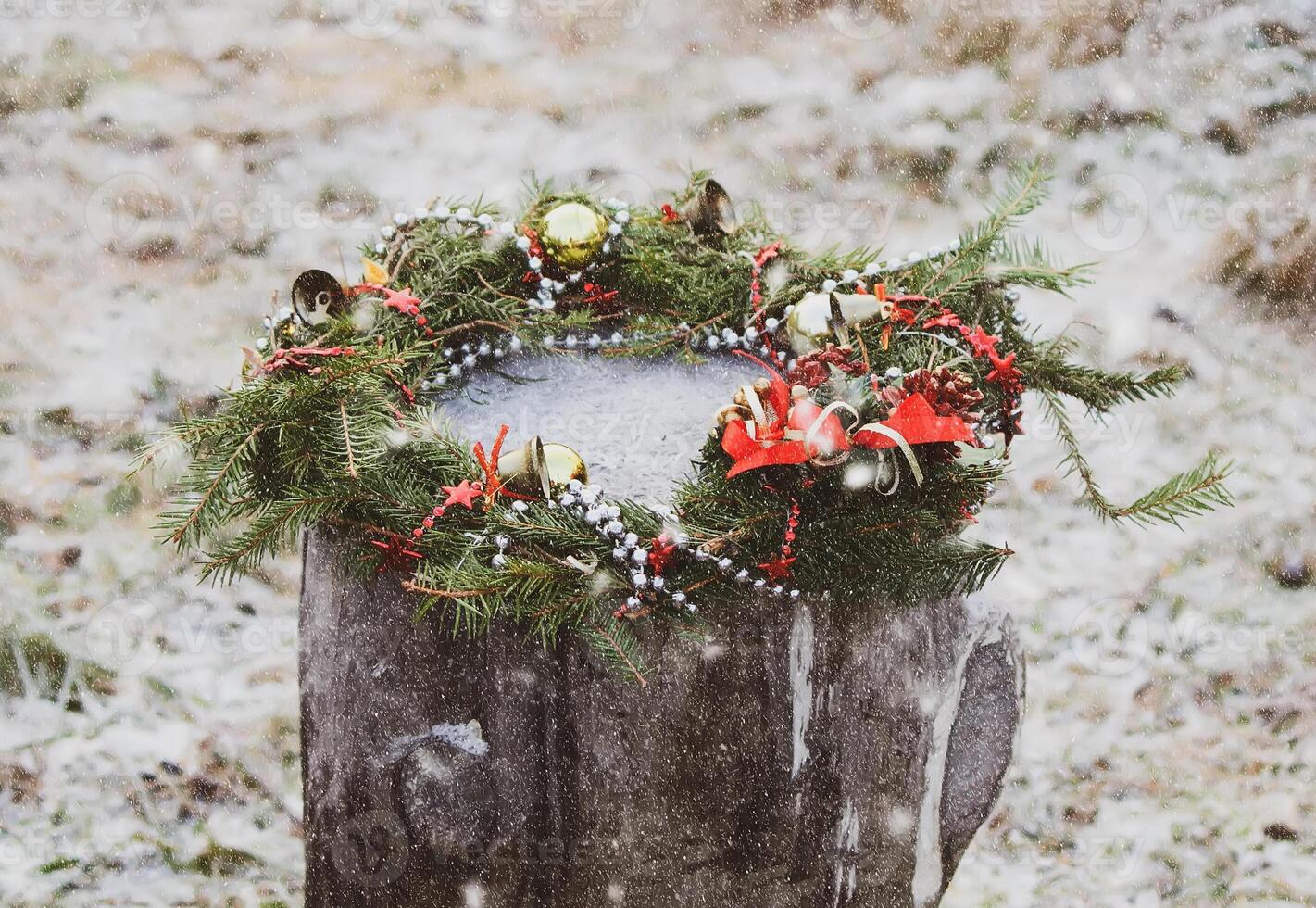 Christmas wreath on a tree stump photo