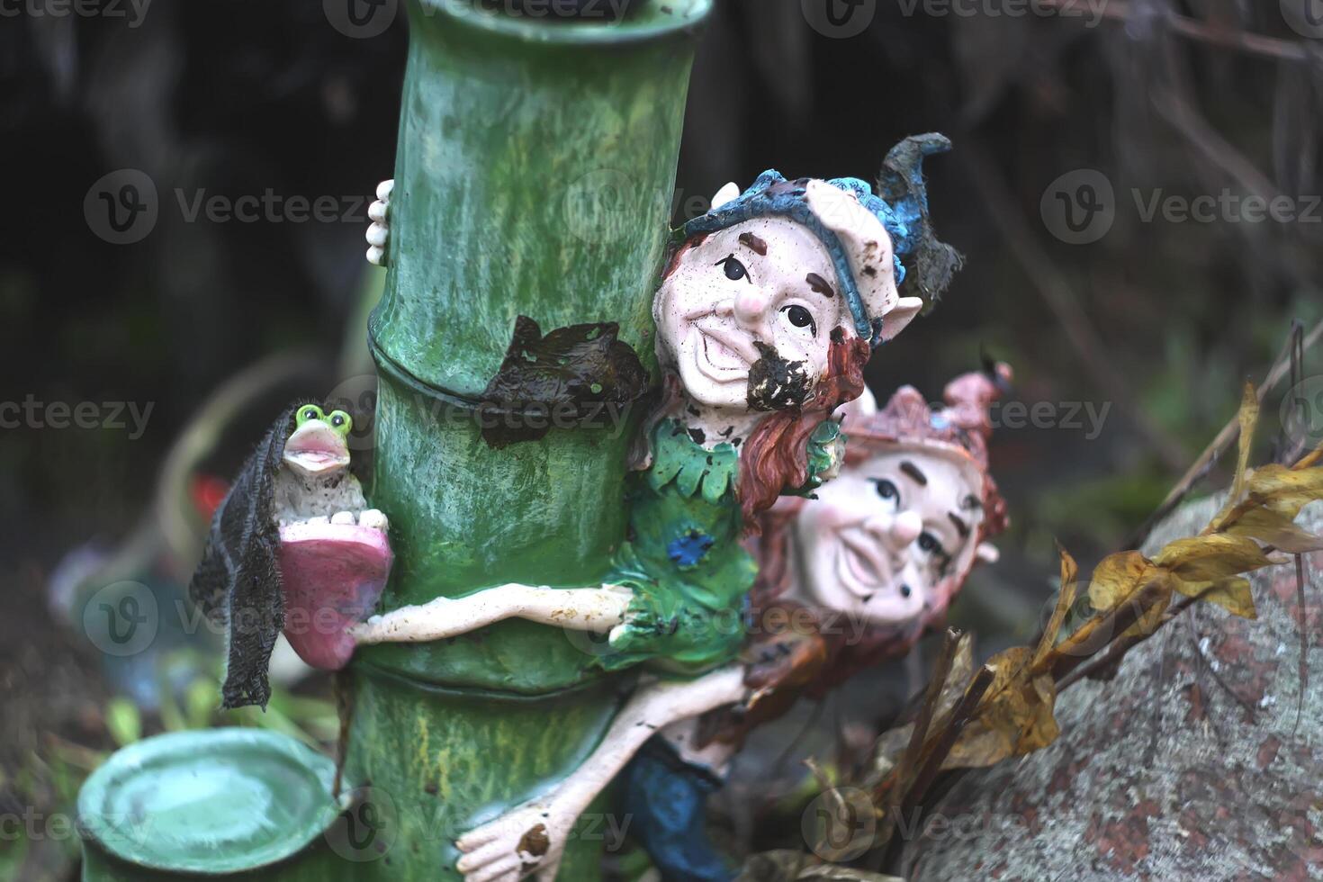 Ceramic elves garden decor standing on the ground photo
