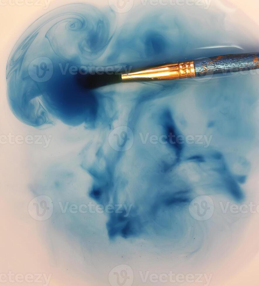 Brush closeup dip with watercolor paint photo