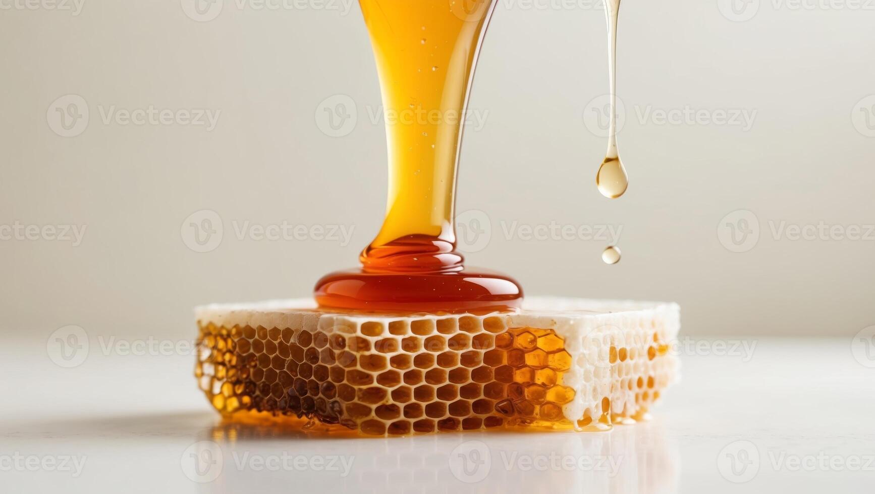 Closeup of golden honey dripping from honeycomb. photo