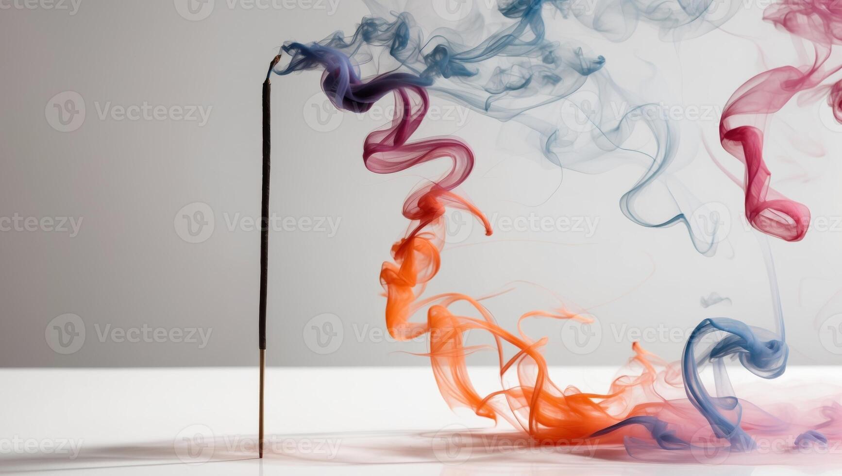 Colorful smoke swirls from incense stick. photo