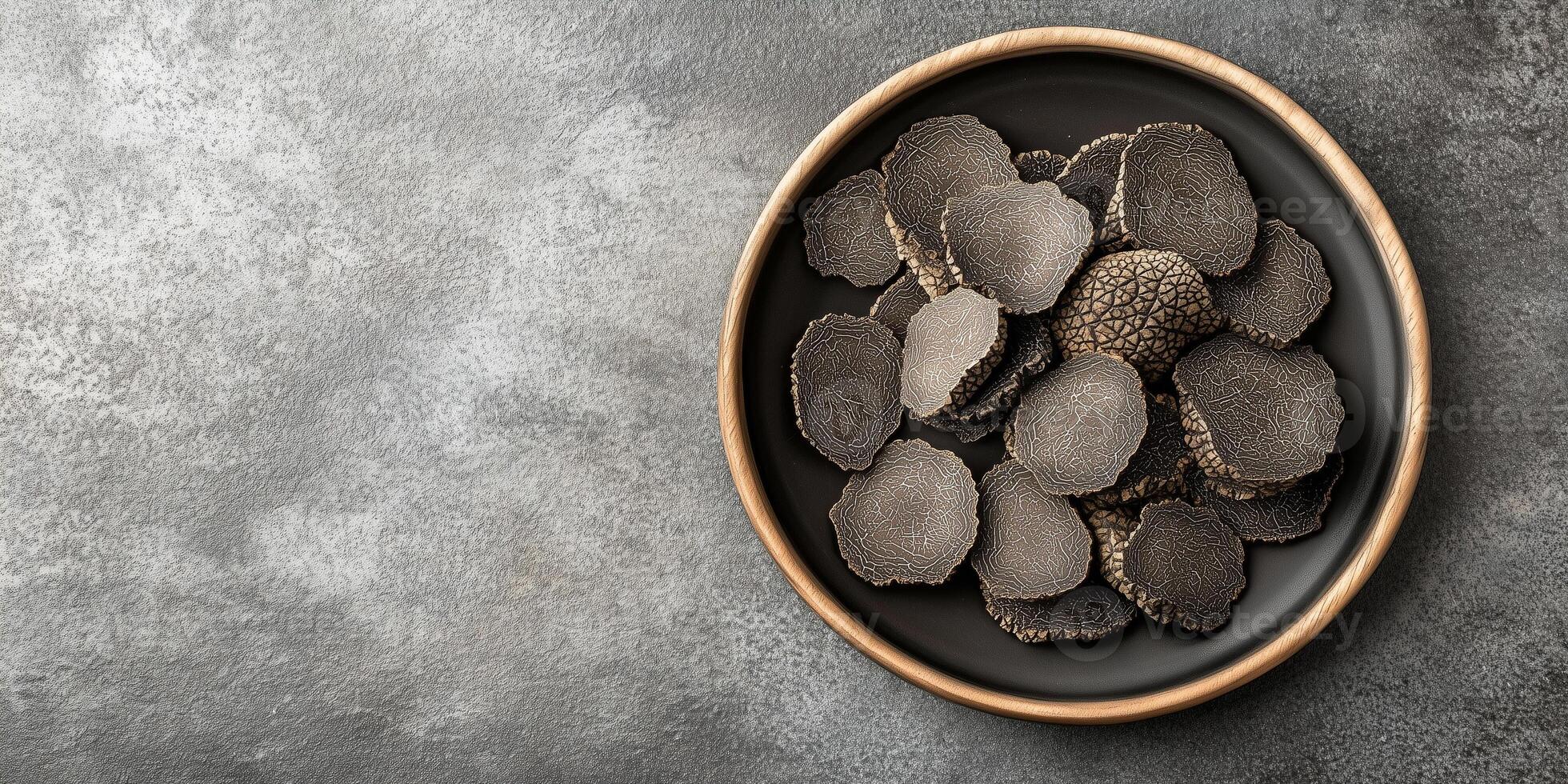 Whole and sliced black truffles arranged neatly on a serving platter, food photography photo