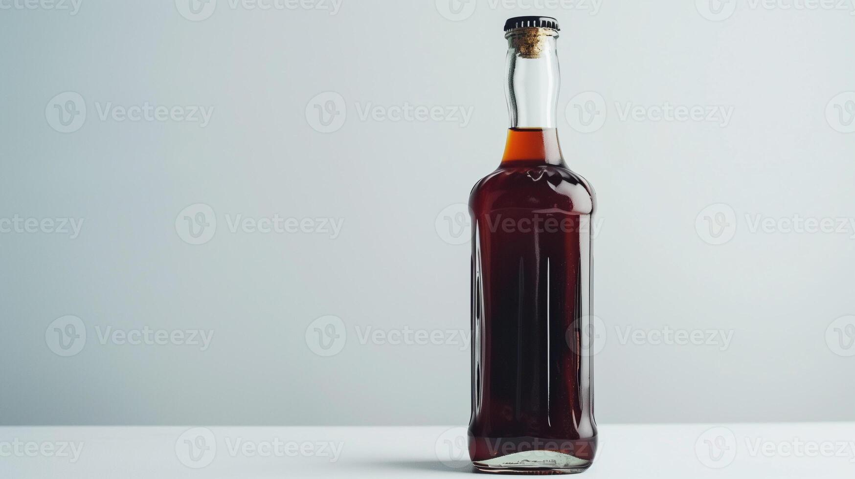 Narrow, tall glass bottle holds a dark syrup, positioned on a plain white surface, food photography photo