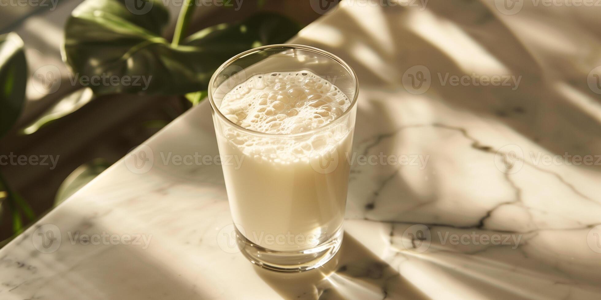 Glass of probiotic yogurt drink with an even consistency, placed on a marble table, meal photography photo