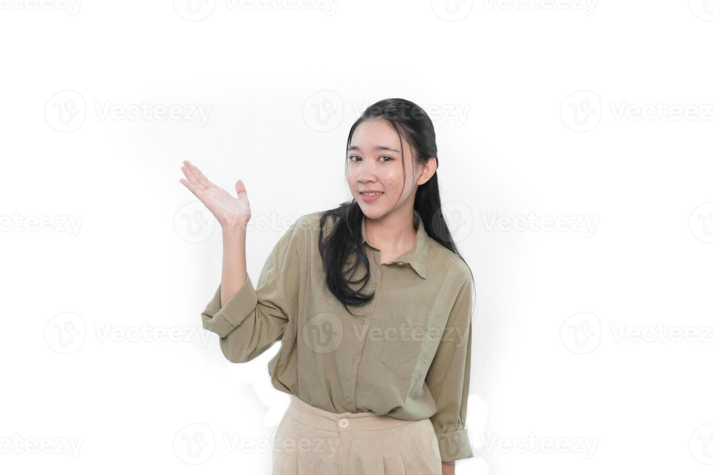 The smiling expression of an Indonesian Asian woman in green and raising one hand to the side photo