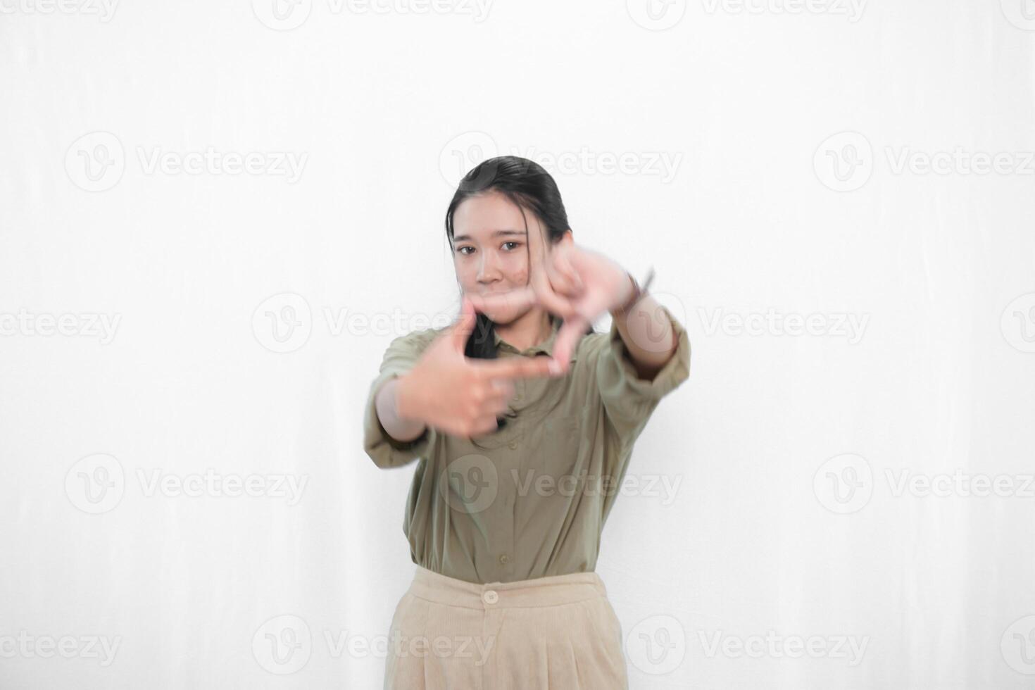 Expression of Indonesian Asian woman in green dress making portrait sign photo