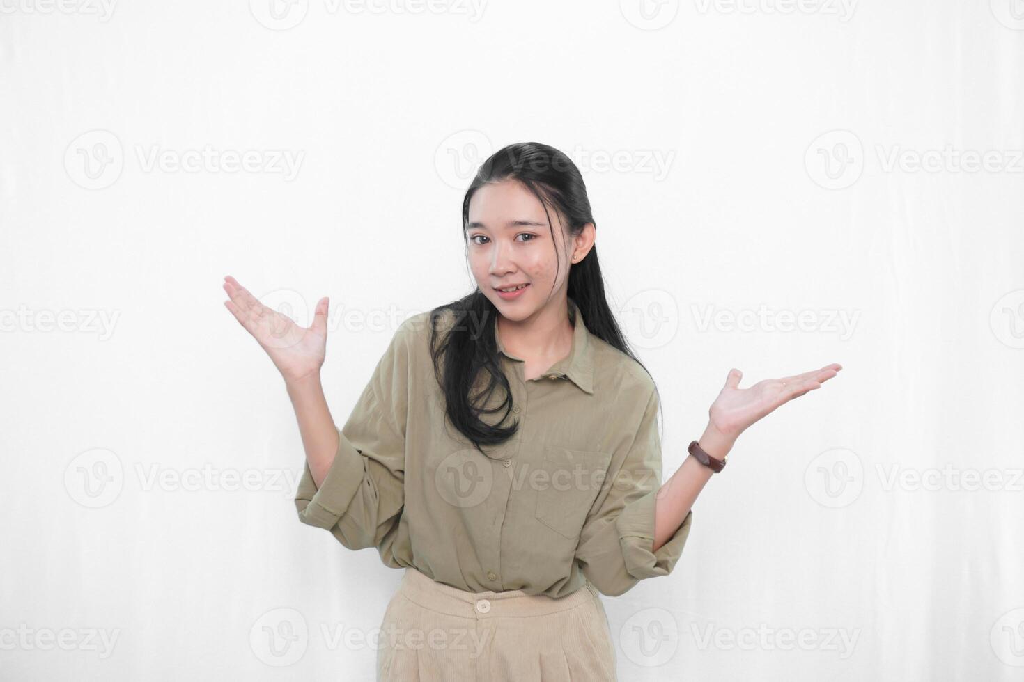 The smiling expression of an Indonesian Asian woman in green and raising both hands to the side photo