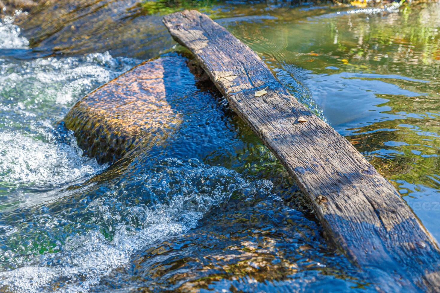 flow of water and spray from a stone photo