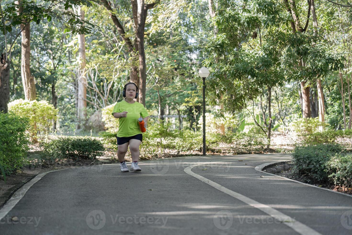 Empowered Young Woman with Disability Jogging for Fitness in a Park Setting, Embracing an Active Lifestyle and Overcoming Challenges photo