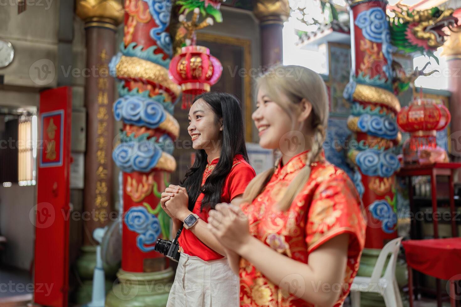 Celebrating chinese new year joyful women in traditional attire cultural temple festive atmosphere close-up view community spirit photo