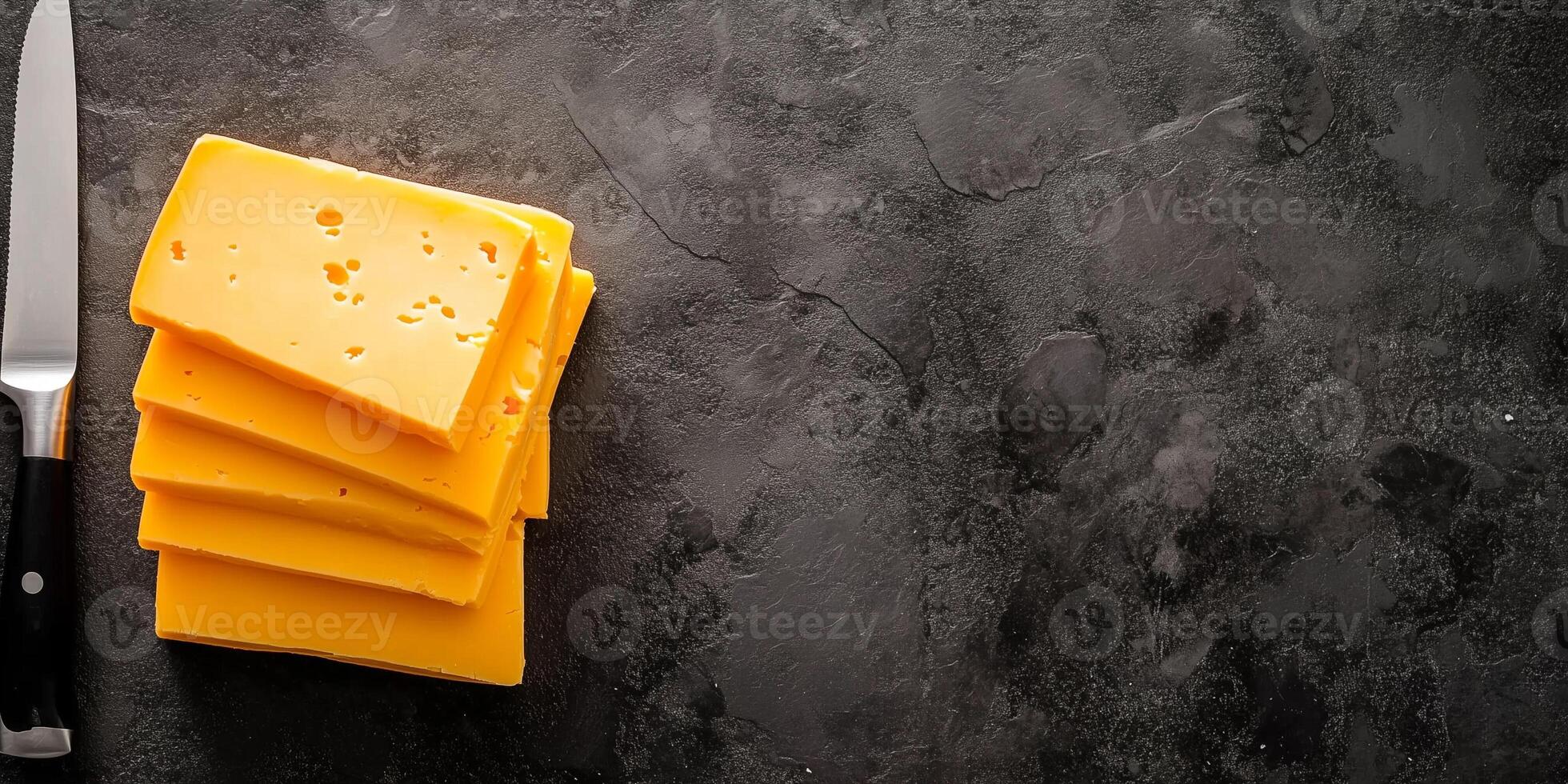 Close-up of cheddar cheese slices stacked neatly on flat surface with knife, culinary photography photo