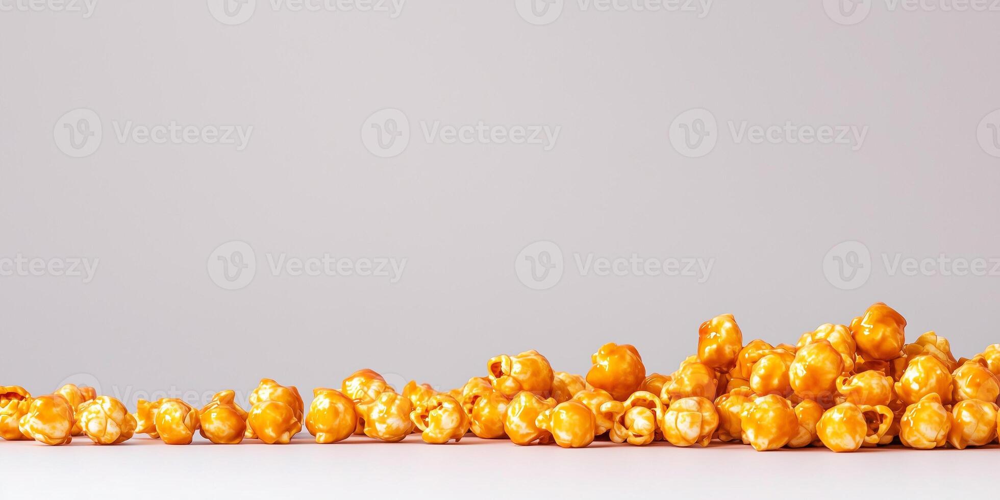 Caramel corn piled high, with coated popcorn arranged on a plain background, food photography photo
