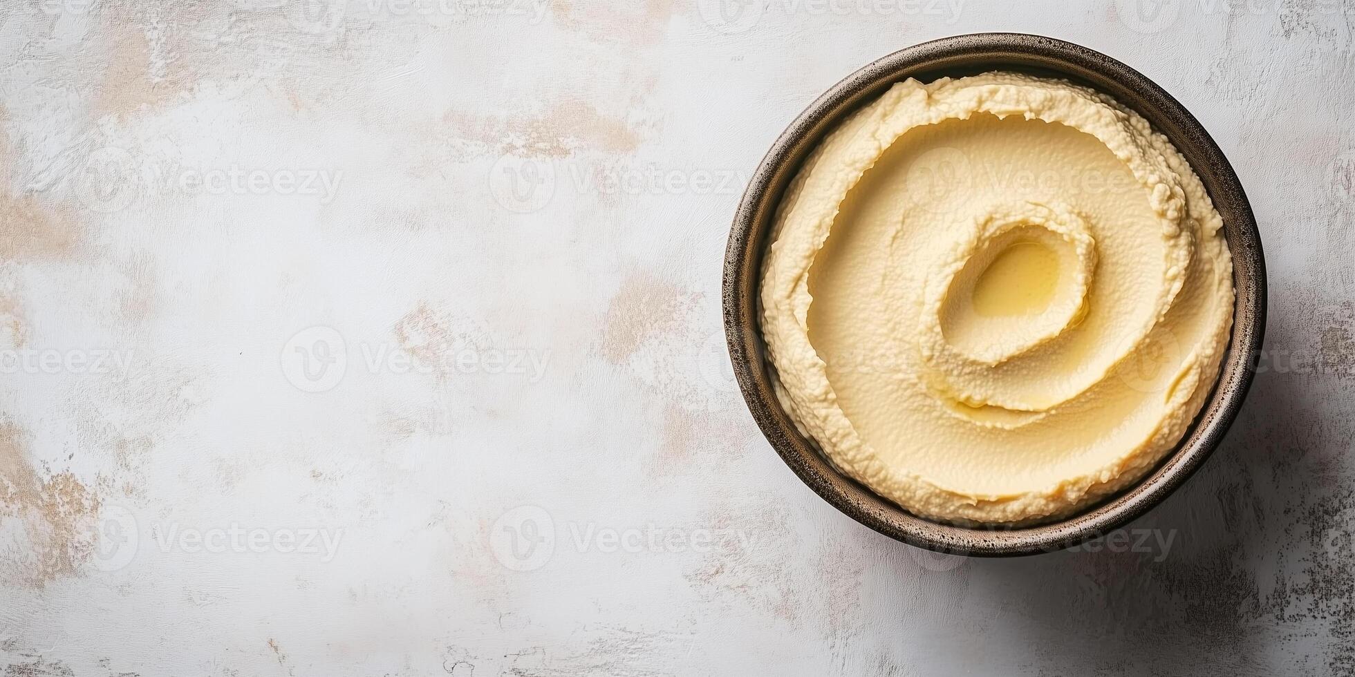Close-up of hummus in a wide bowl with a smooth, undisturbed surface, photorealistic food photo
