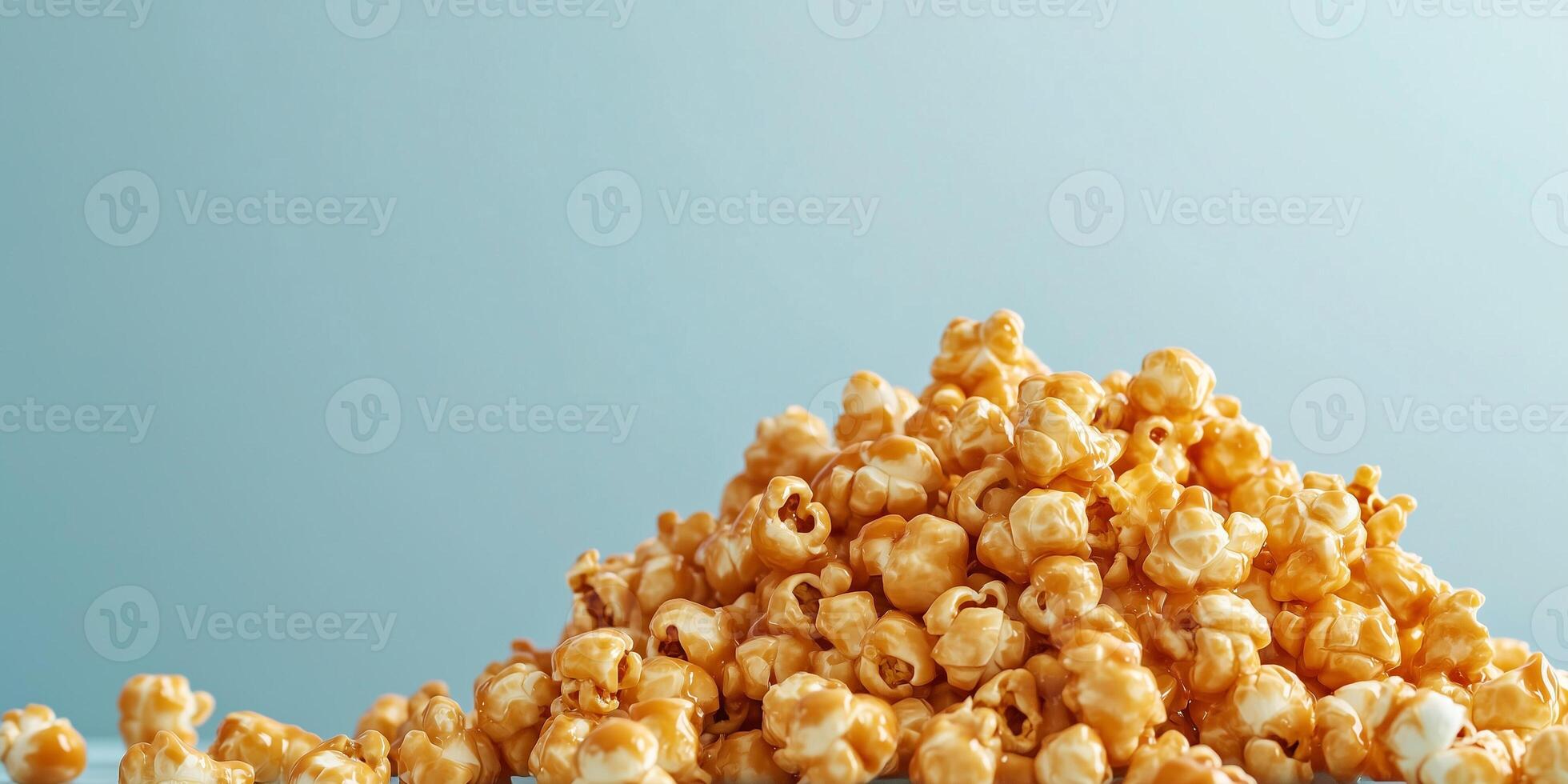 Caramel corn piled high, with coated popcorn arranged on a plain background, food setting photo