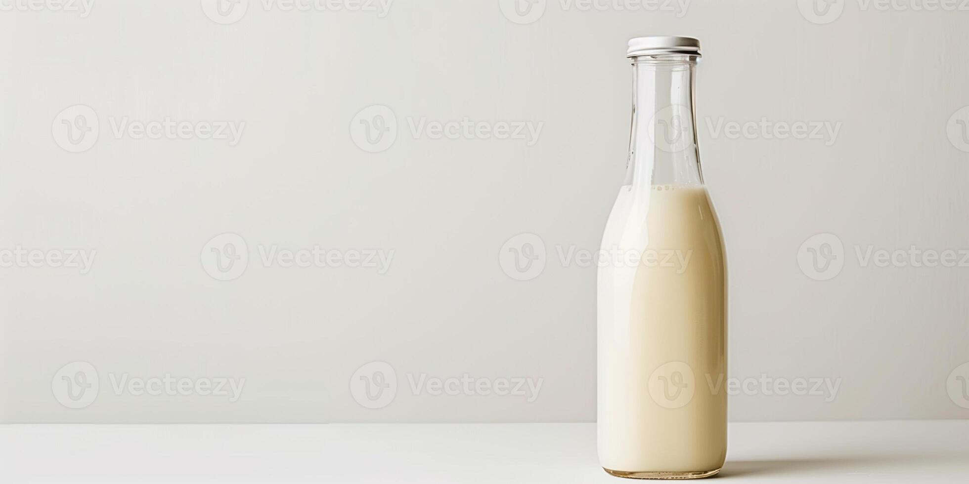 Clear bottle of probiotic drink with light-colored liquid on white background, meal photography photo