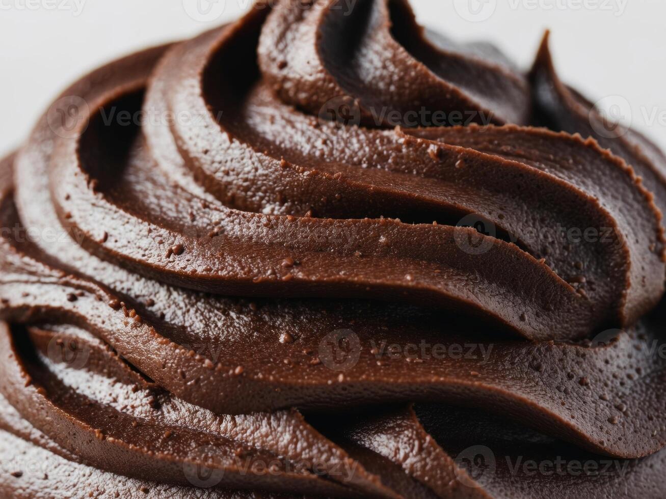 close up image of dark brown chocolate frosting with rough textured surface. photo