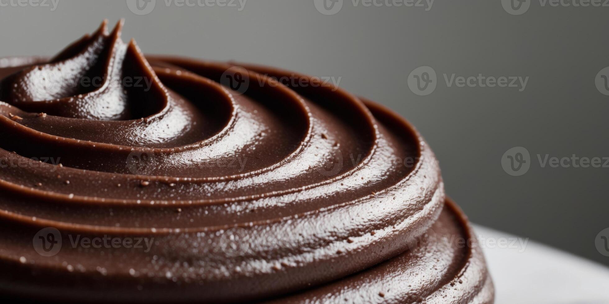 close up image of dark smooth surface chocolate frosting. photo