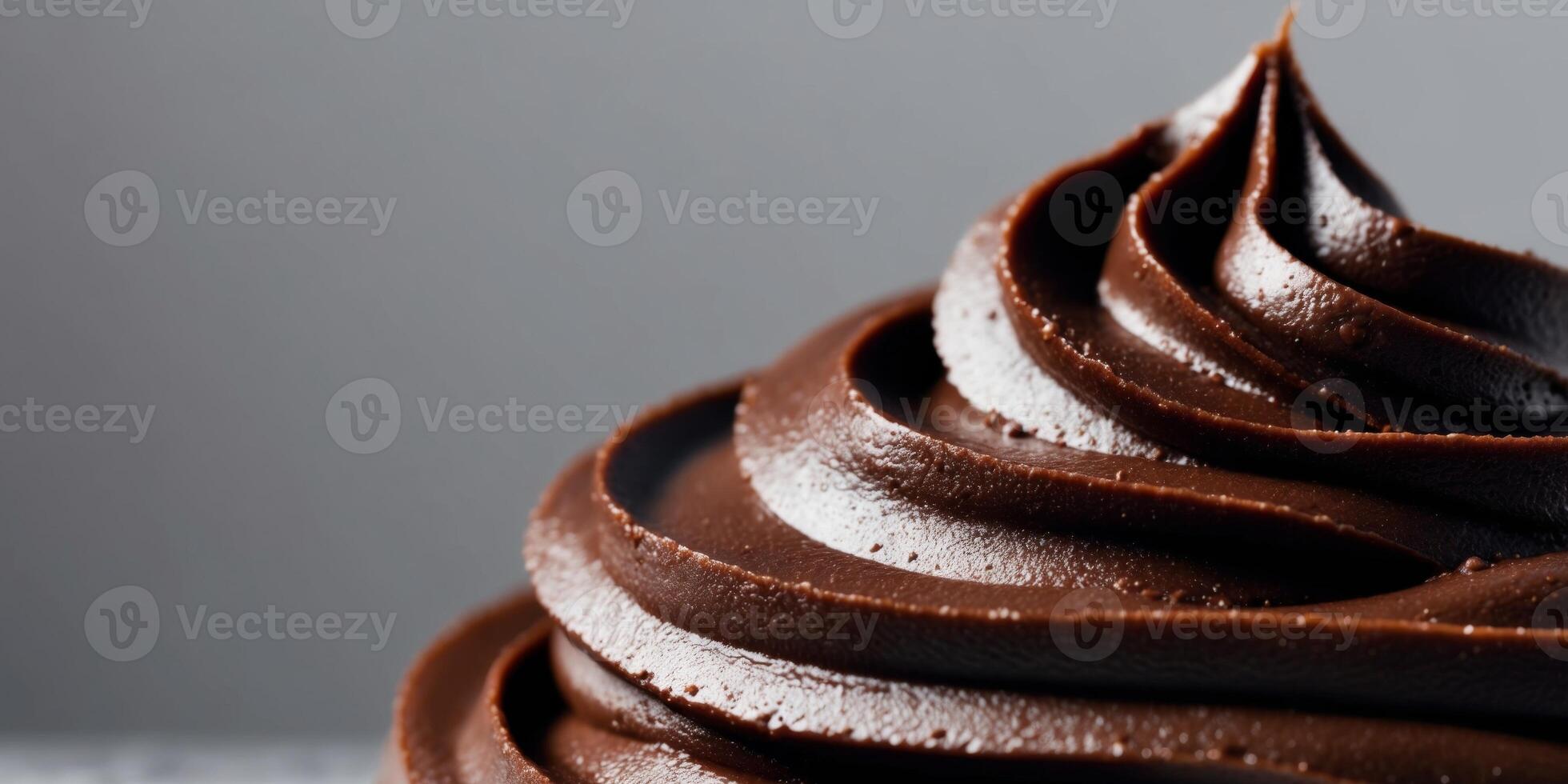 close up image of dark smooth surface chocolate frosting. photo