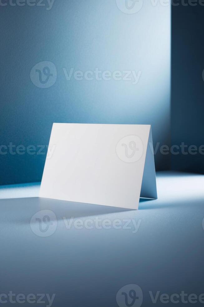 A white card is placed in the middle of a blue background. photo