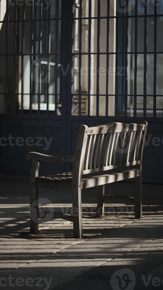 Weathered bench facing dimly lit bars, casting contemplative, serene shadows Vertical Mobile Wallpaper photo