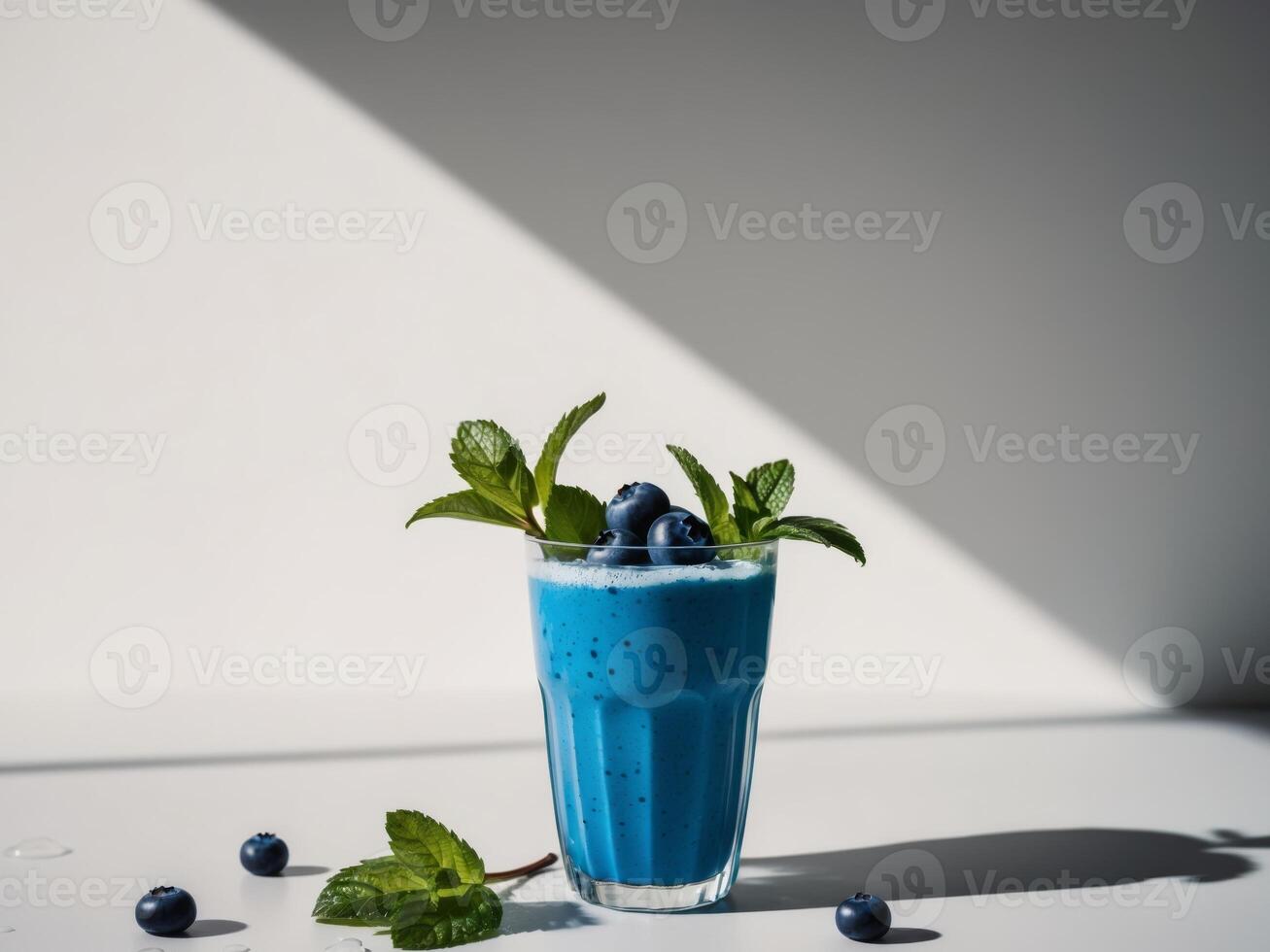 A vibrant blueberry smoothie adorned with fresh berries and mint leaves. photo